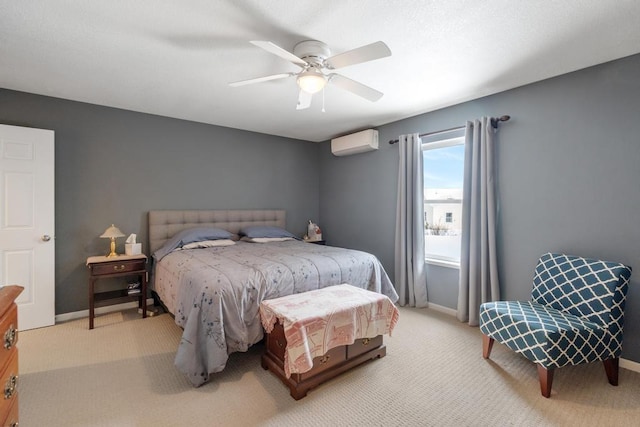 bedroom with a wall unit AC, ceiling fan, and light colored carpet