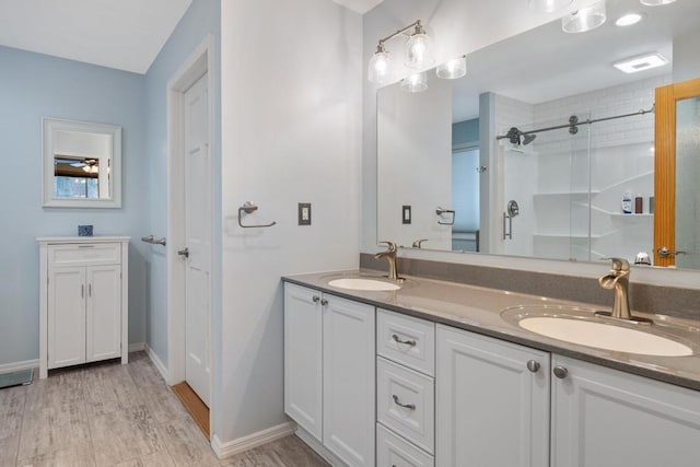 bathroom featuring vanity, an enclosed shower, and hardwood / wood-style flooring