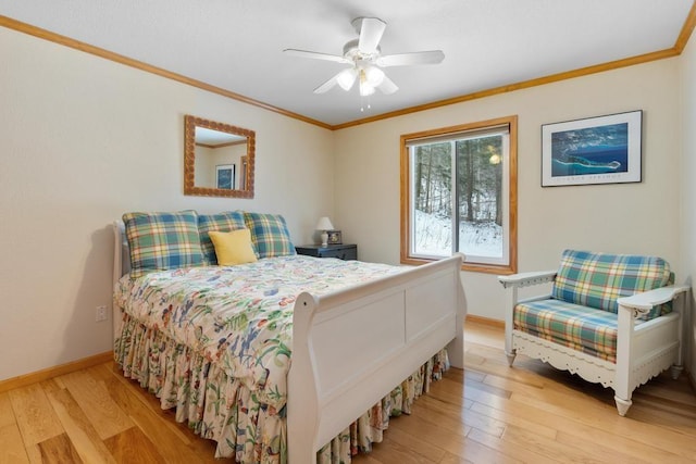 bedroom featuring ceiling fan, light wood-type flooring, and crown molding