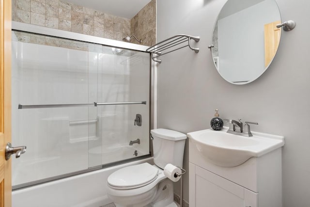 full bathroom with shower / bath combination with glass door, vanity, and toilet