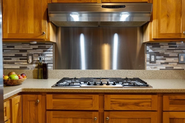 kitchen with backsplash and stainless steel gas stovetop