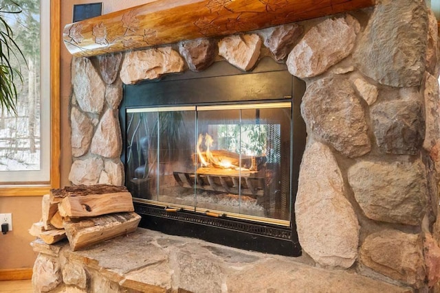 interior details with a stone fireplace