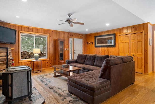 living room featuring light hardwood / wood-style flooring and ceiling fan