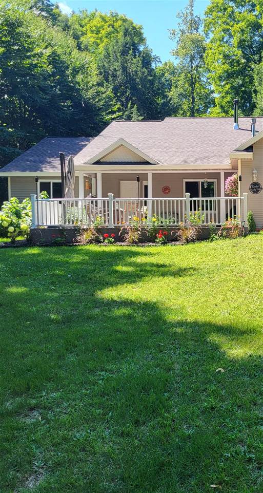 rear view of house with a yard