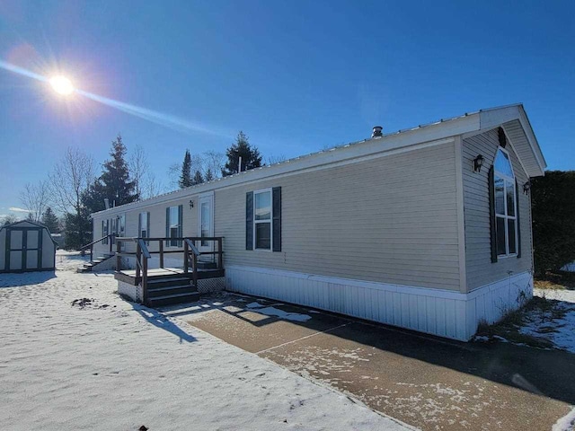 exterior space featuring a storage unit and a deck