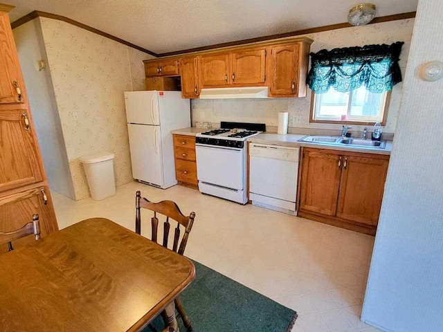 kitchen featuring a textured ceiling, white appliances, sink, and ornamental molding