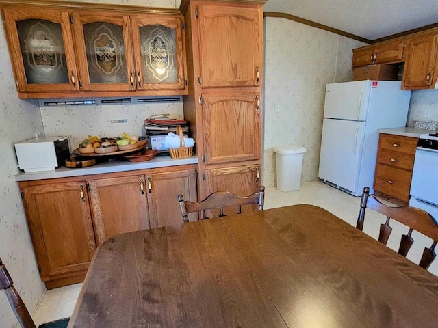 interior space with white appliances and ornamental molding