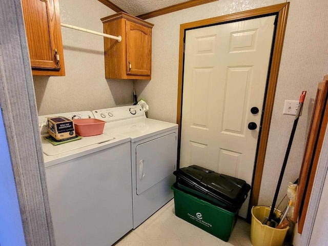 washroom with cabinets, a textured ceiling, separate washer and dryer, and crown molding