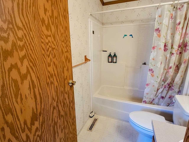 bathroom featuring shower / bathtub combination with curtain and toilet