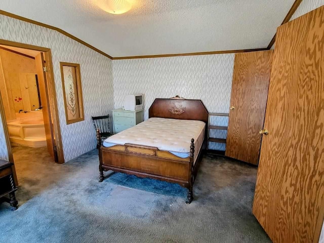 carpeted bedroom featuring lofted ceiling, a textured ceiling, ensuite bath, and crown molding