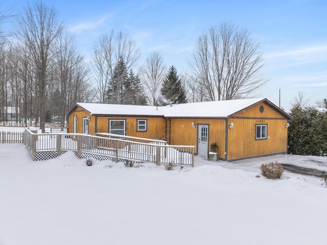 view of snow covered rear of property