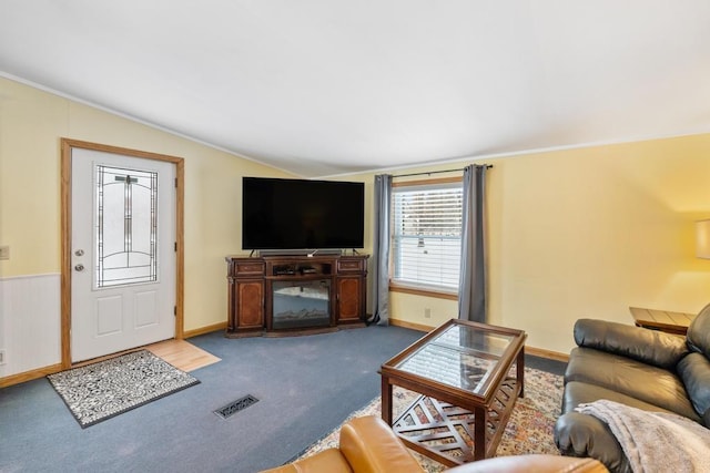 carpeted living room featuring vaulted ceiling and crown molding