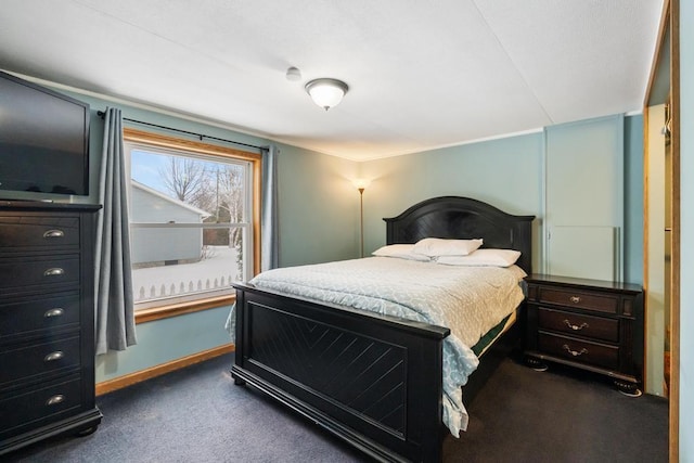 bedroom featuring dark colored carpet