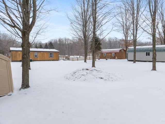 snowy yard featuring an outdoor structure