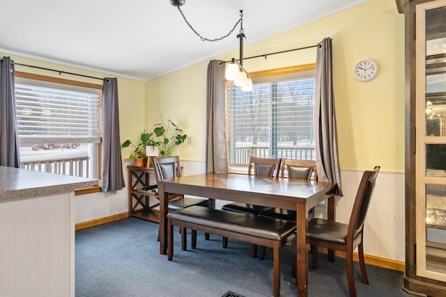 dining area featuring dark colored carpet