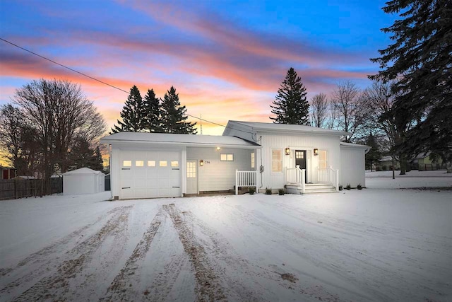 view of front facade featuring an outbuilding and a garage