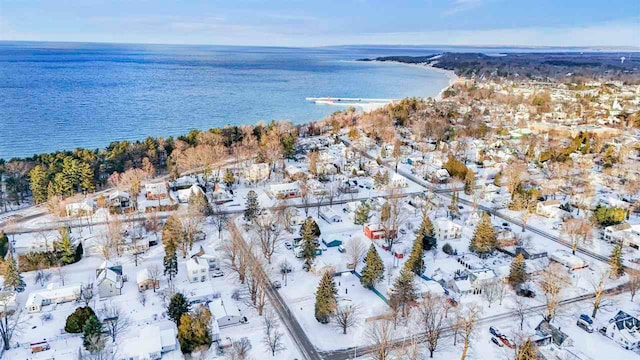 snowy aerial view with a water view