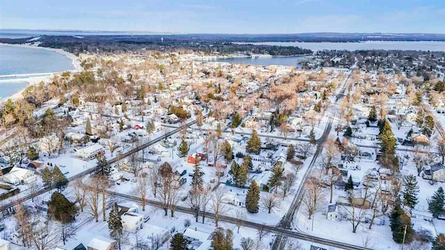 snowy aerial view with a water view