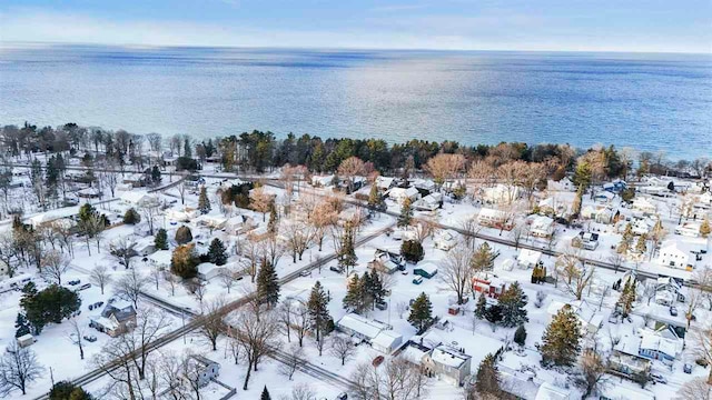 snowy aerial view featuring a water view