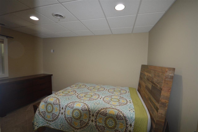 bedroom featuring carpet and a paneled ceiling