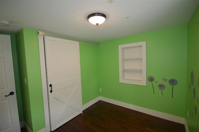 unfurnished bedroom featuring dark hardwood / wood-style floors