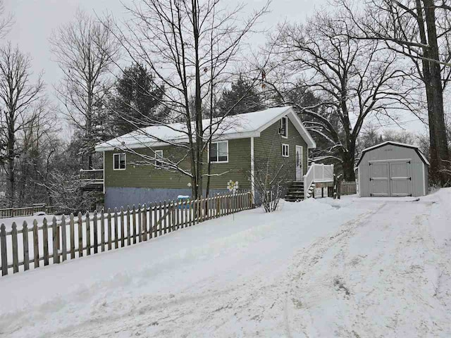 exterior space with a storage shed and a deck