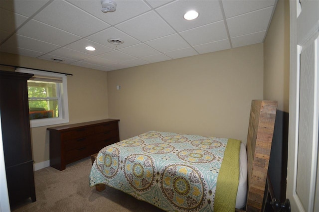 carpeted bedroom featuring a paneled ceiling