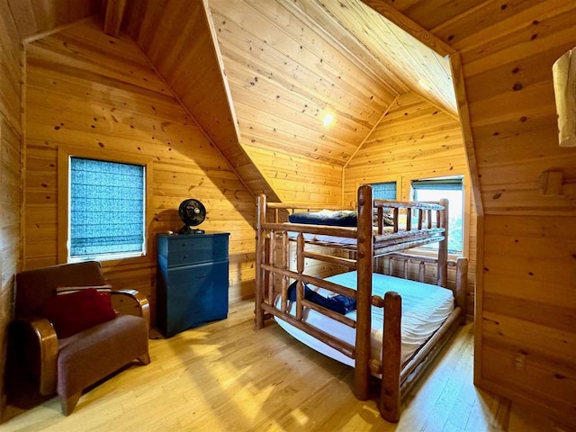 bedroom featuring wooden ceiling, vaulted ceiling, and wood walls