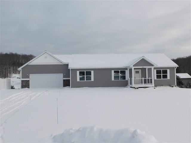 single story home featuring a porch and a garage