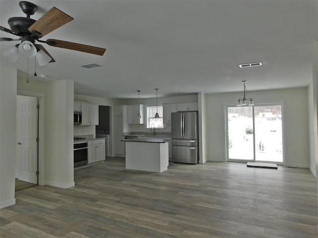 kitchen featuring white cabinetry, a kitchen island, pendant lighting, and appliances with stainless steel finishes