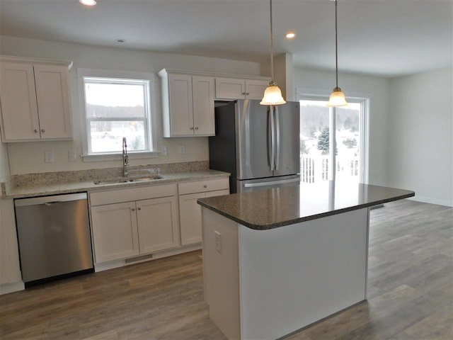 kitchen featuring white cabinets, a center island, and stainless steel appliances