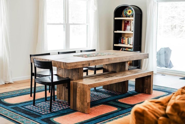 dining area featuring hardwood / wood-style flooring and a healthy amount of sunlight