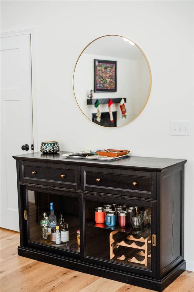 bar with light hardwood / wood-style floors