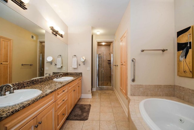 bathroom with shower with separate bathtub, vanity, and tile patterned floors