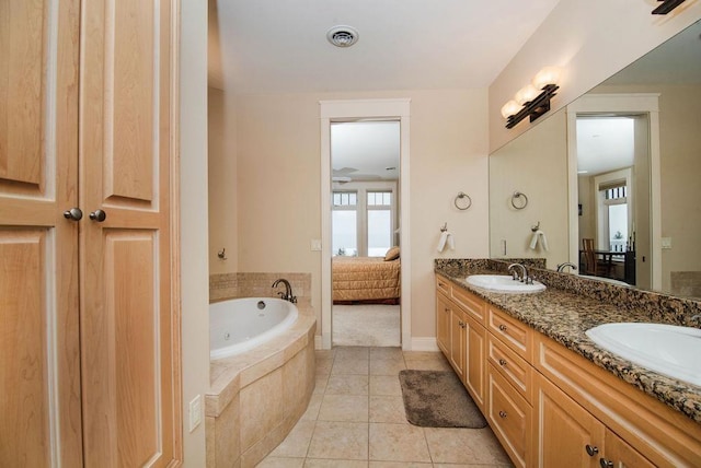 bathroom featuring tiled bath, ceiling fan, tile patterned floors, and vanity