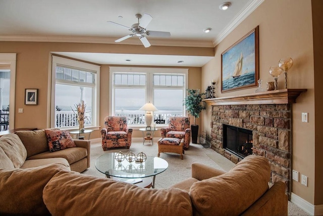 living room with a fireplace, light carpet, ceiling fan, and crown molding