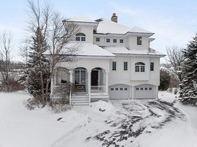 view of front of property featuring covered porch and a garage