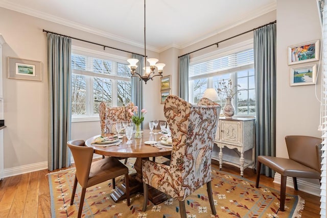 dining room featuring ornamental molding, a chandelier, and wood-type flooring