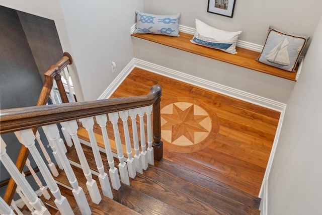 staircase with hardwood / wood-style floors