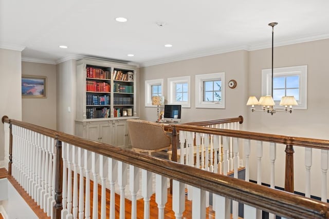 hallway featuring a notable chandelier and crown molding