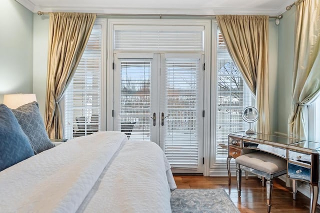 bedroom featuring hardwood / wood-style floors, access to exterior, and ornamental molding