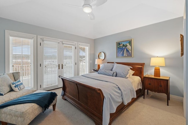 bedroom featuring light carpet, ceiling fan, access to exterior, and multiple windows