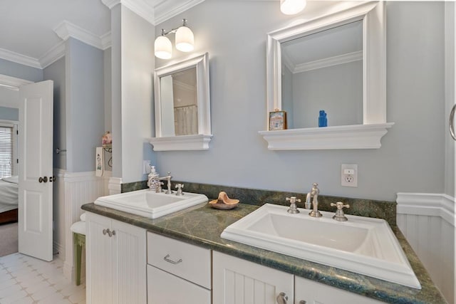 bathroom with crown molding and vanity