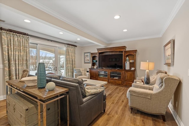 living room featuring crown molding and light hardwood / wood-style flooring