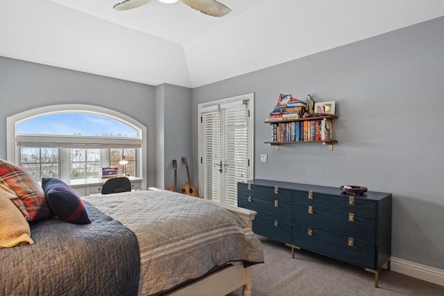 bedroom with ceiling fan, vaulted ceiling, and carpet