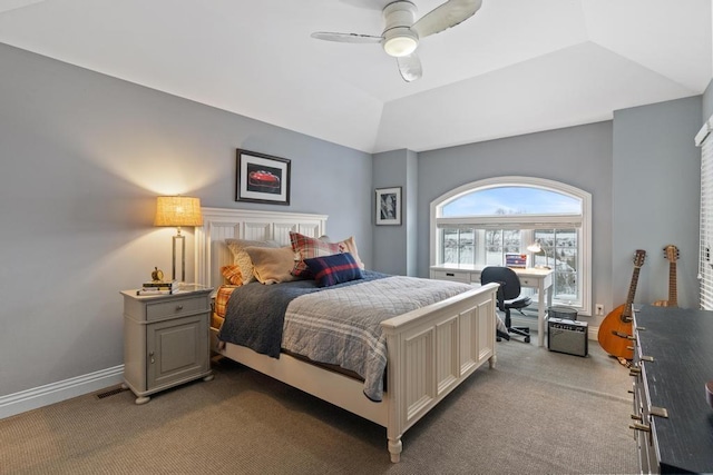 bedroom featuring ceiling fan, light colored carpet, and a tray ceiling