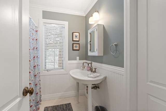 bathroom with tile patterned flooring and ornamental molding