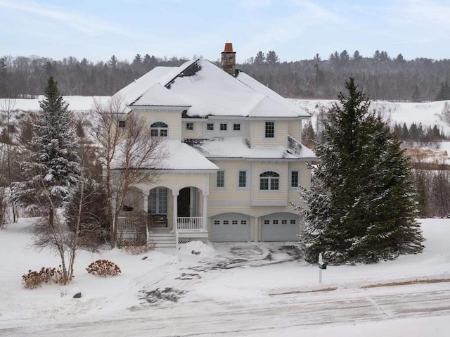 view of front of property featuring covered porch and a garage