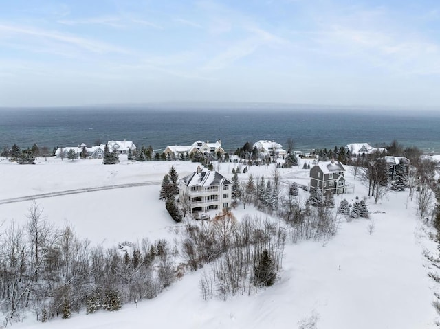 snowy aerial view featuring a water view