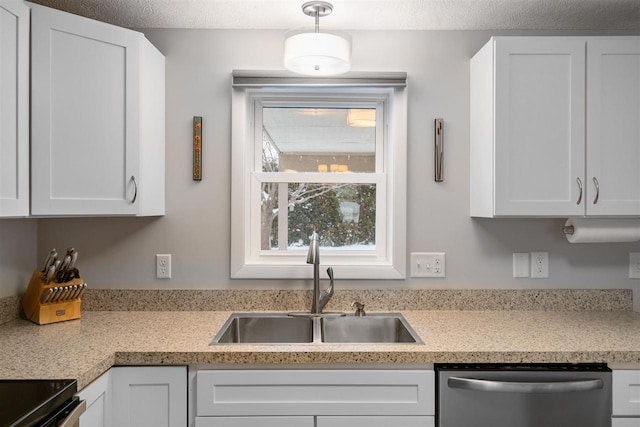 kitchen with stainless steel dishwasher, white cabinets, sink, and pendant lighting